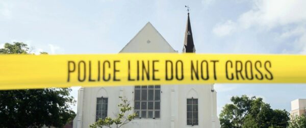 Police line tape at a church that says Do not cross