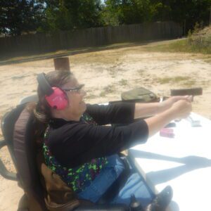 Shooting a handgun from a wheelchair.